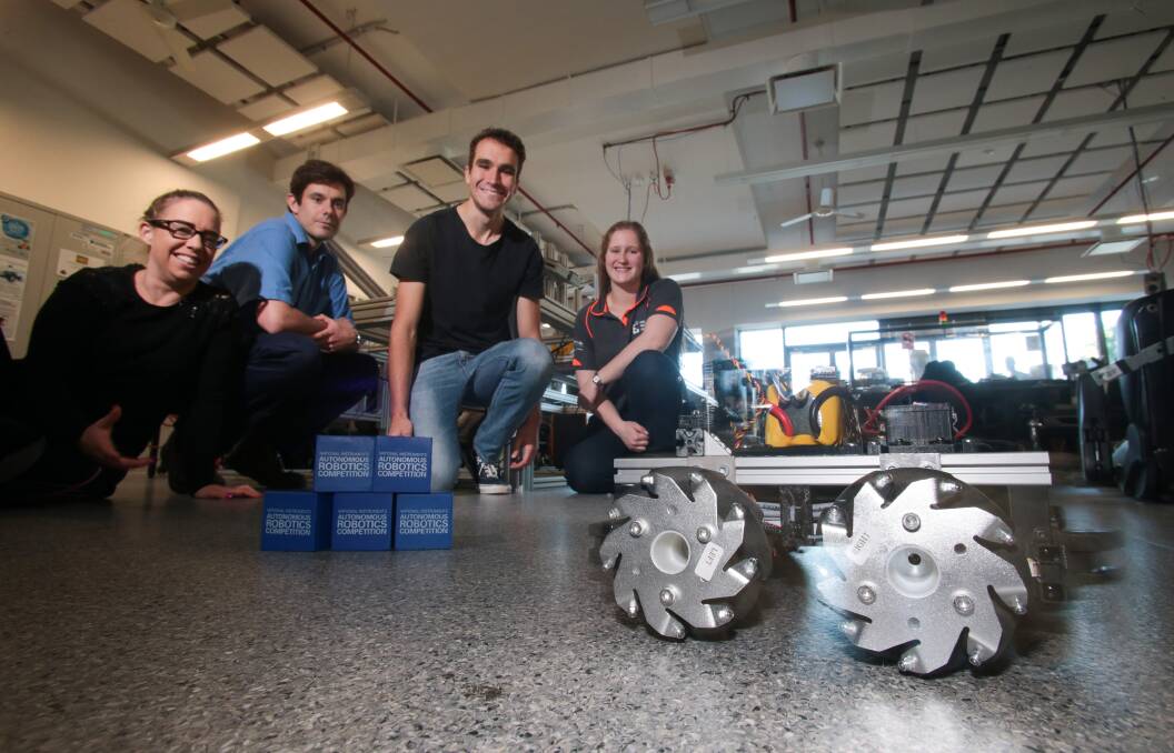 Alison Haire, Doug Henness, Andrew Short, Sophie Counsell from the University of Wollongong with their robotic creation for the coming Autonomous Robotics competition. Picture: ADAM McLEAN