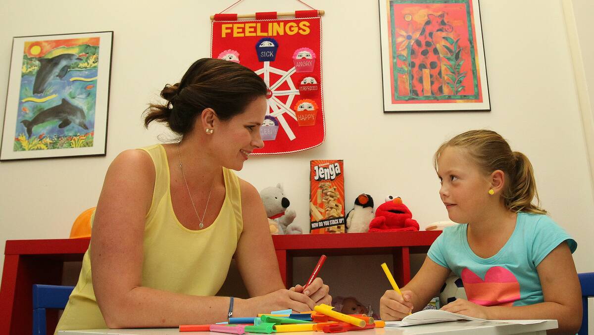 Corrimal eight-year-old Kayla Farrar draws with Northfields Clinic therapist Annie Bouvard. Picture:  GREG TOTMAN