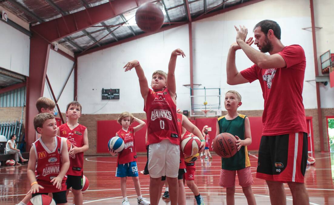 Riley Broadhead takes a shot as Wollongong Hawk Rhys Martin looks on during a coaching clinic at the Snakepit. Picture: ADAM McLEAN