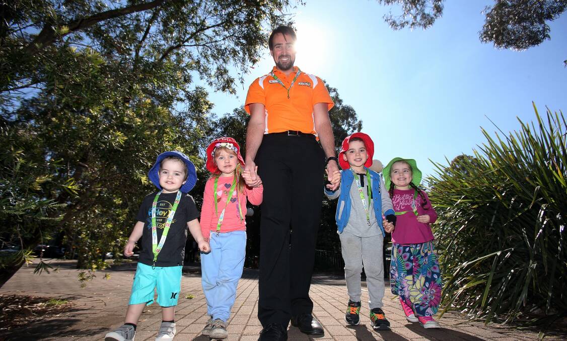 KidzWish events co-ordinator Beau Thatcher with Lennon Holtom, 2, Ava Rasmussen, 4, Ricardo Vega, 5 and Harlow Holtom, 3, from the University of Wollongong’s Kids’ Uni childcare centre. Picture: ROBERT PEET
