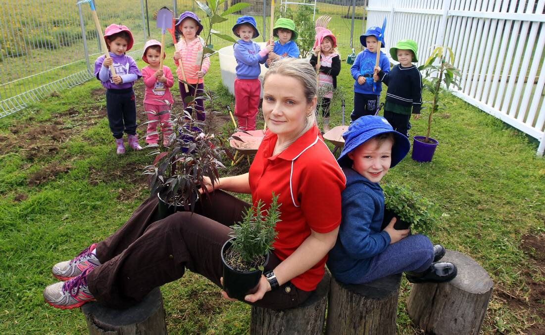 Little School Preschool director Danae Horsey, with Harlow, Olivia and helpers doing their part to plant trees on National Tree Day on Friday, adding donations to their Secret Garden. Picture: SYLVIA LIBER