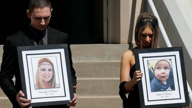 Relatives of Bianka and Jude O'Brien carry their photographs at their funeral. Picture: Daniel Munoz


