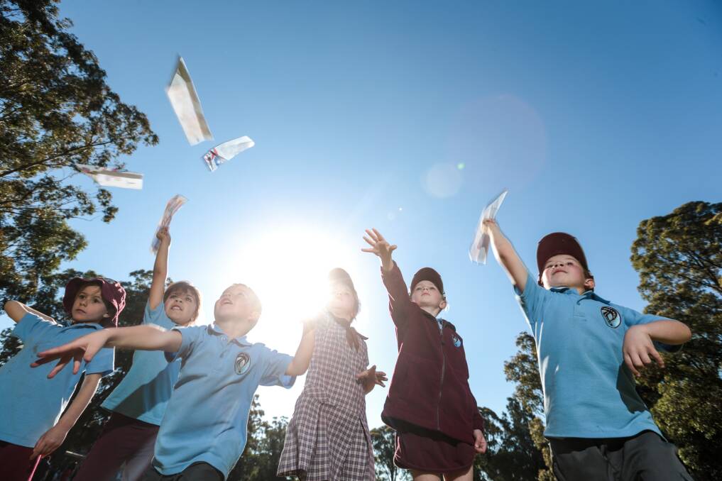 Lakelands Public School kindergarten kids throw paper planes. Picture: ADAM McLEAN