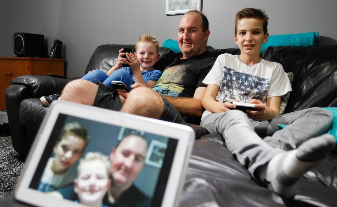 Jason Bennett with sons Blake, 11 and Riley, 4, who use lots of internet at home.  Picture:  CHRISTOPHER CHAN