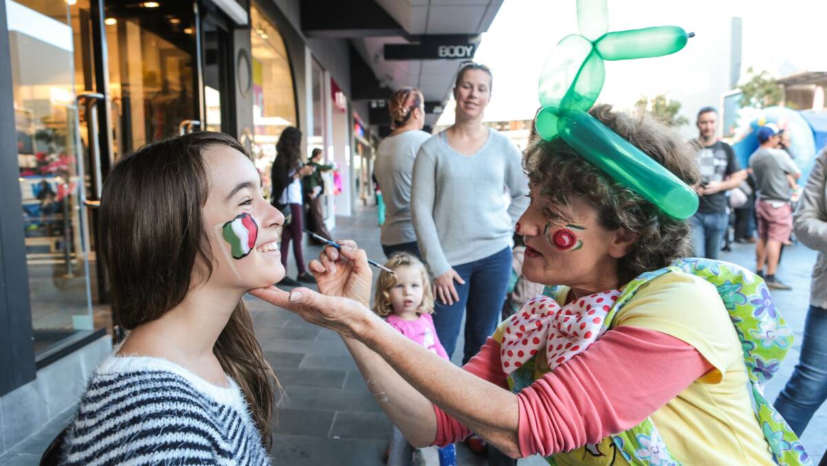 Skye Zaracostas has her face painted by Cristina Velez. Picture: ADAM McLEAN