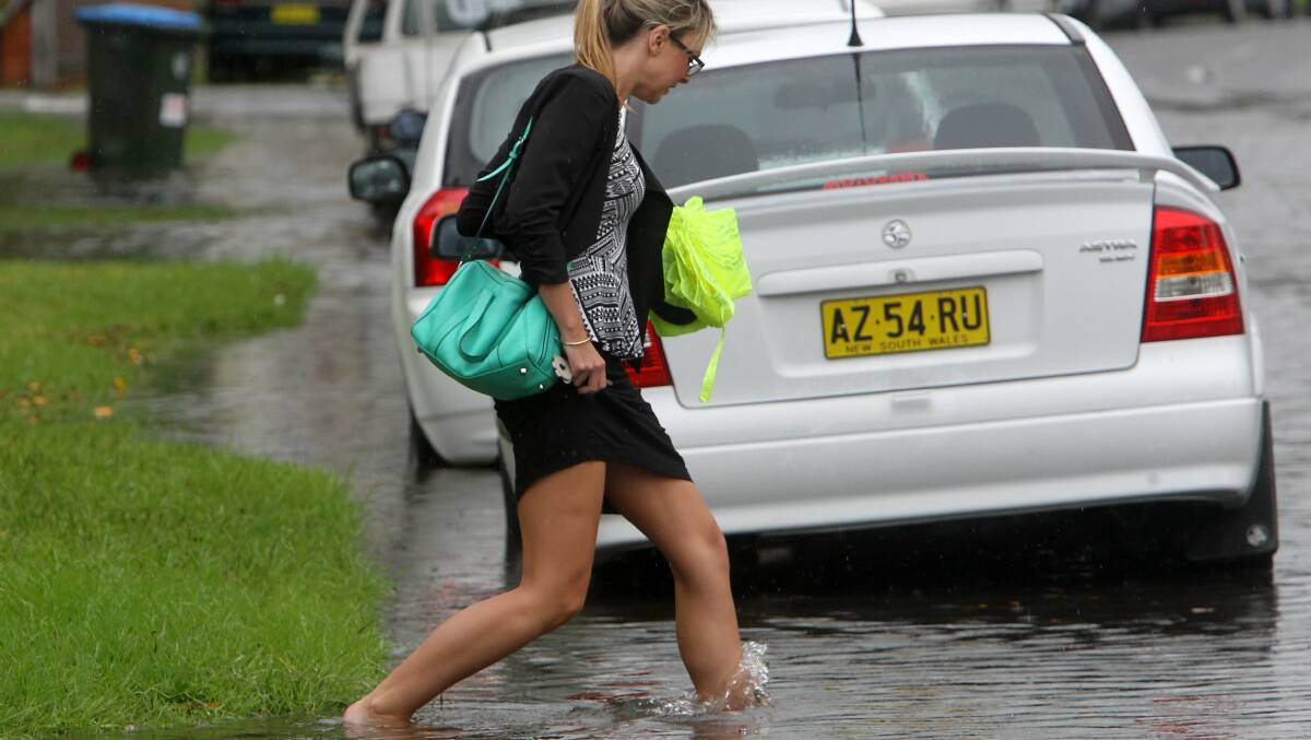 A motorist negotiates the flash flooding in Montague Street. Picture: GREG TOTMAN