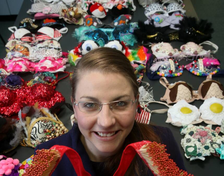 BreastScreen Wollongong health promotion officer Sarah Little with some of the extraordinary embellished bras entered in last year’s Bling A Bra competition for breast cancer.  Picture: ROBERT PEET