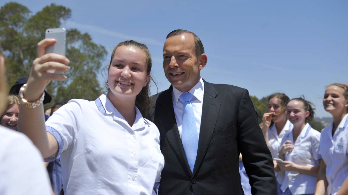 Tony Abbott has a selfie taken with a student at an all-girls private school in Canberra in November. Picture: JAY CRONAN