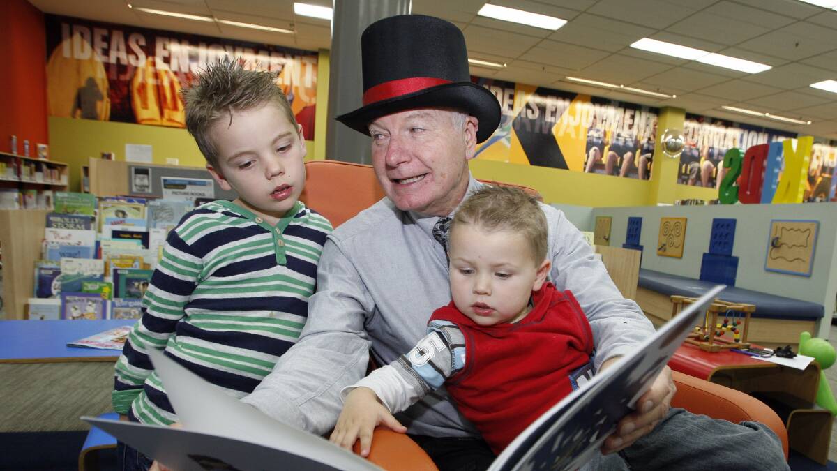 Wollongong mayor Gordon Bradbery in the city library last year, reading with Jake and Toby Wachsmuth.