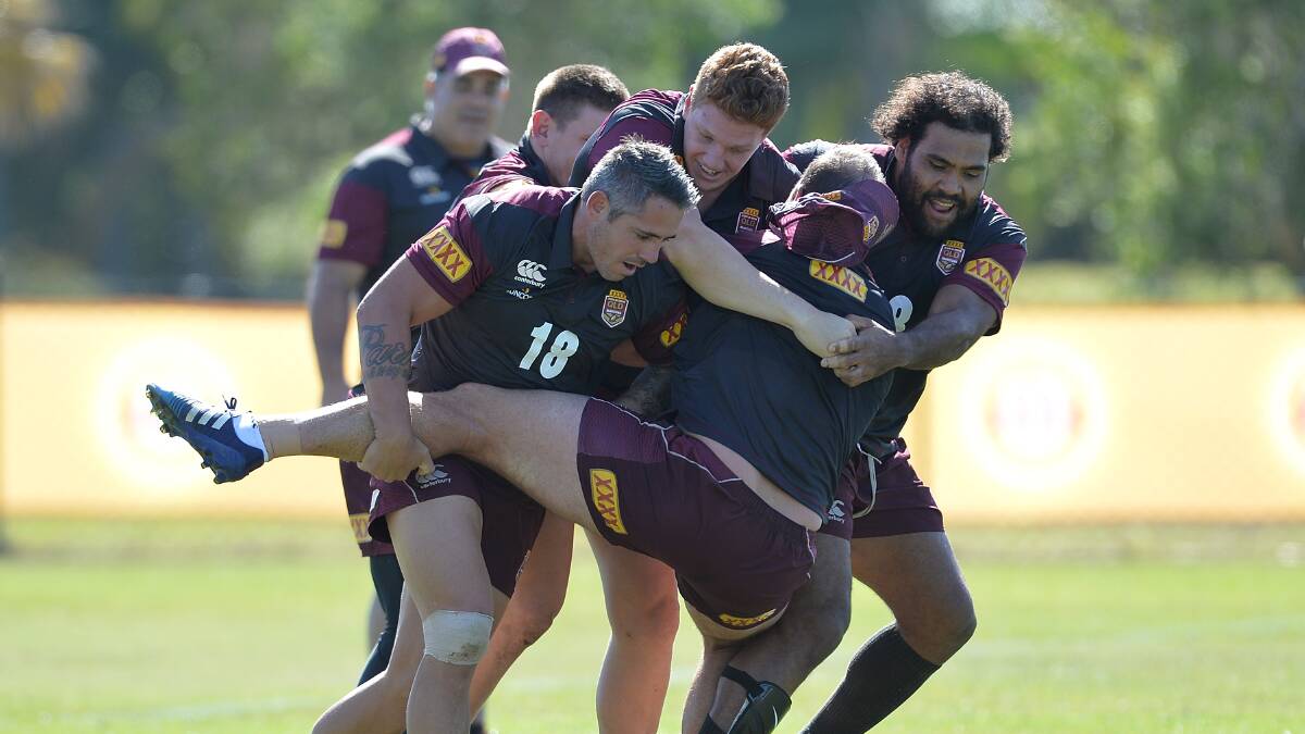 Matt Scott is tackled by Sam Thaiday and Corey Parker during the Queensland Maroons State of Origin training session. Picture: GETTY IMAGES