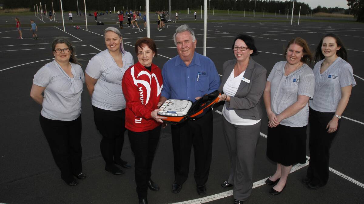 Sandra Curll (left), Sarah Hicks, Dianne Elvy, Bob Glover, Kate Sherlock, Kylie Nigro and Aimee Murray on hand as Berkeley Netball Association receives a defibrillator donated by All States Medical Supplies after a competitor died of a heart attack  recently.  Picture: ANDY ZAKELI