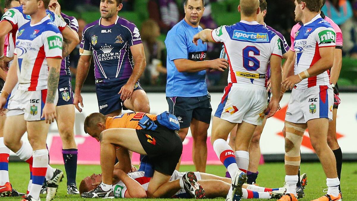 Alex McKinnon lays on the ground after being tackled on March 24.