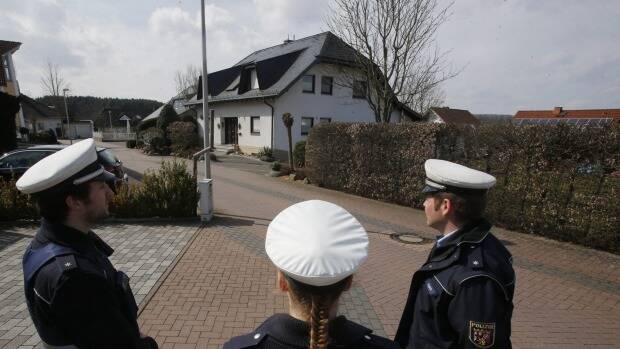 Police hold media away from the house where Andreas Lubitz lived in Montabaur, Germany. Photo: AP