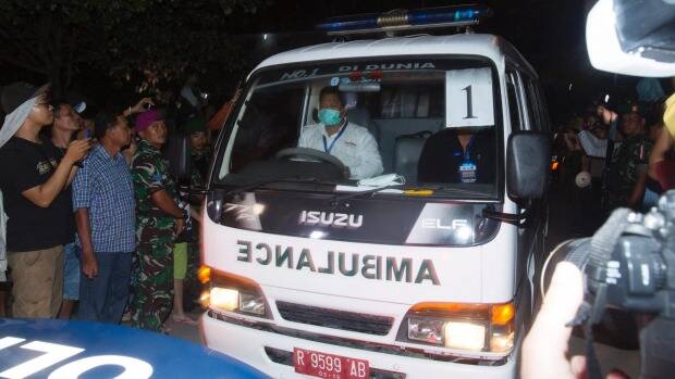 One of the ambulances carrying a coffin of one of the executed leaving Wijaya Pura in Cilacap. Picture: JAMES BRICKWOOD
