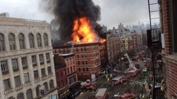 Fire shoots from the roof of a building after it collapsed and burst into flames in New York City's East Village. Photo: REUTERS