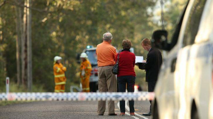 Police interview witnesses at a roadblock near the scene of an ultralight plane crash at Lovedale in the Hunter Valley. Picture: DEAN OSLAND