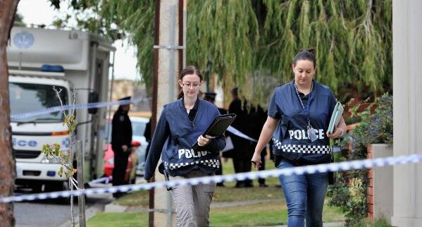 Police outside the home of Phil Walsh. Picture: DAVID MARIUZ