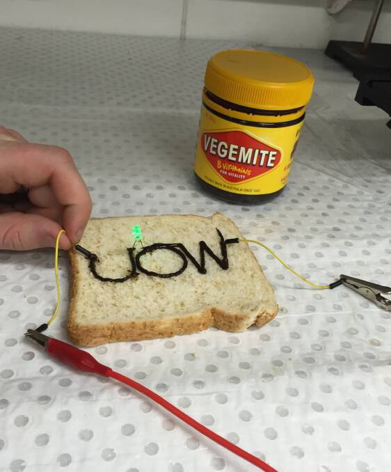 UOW's Professor Marc in het Panhuis has created a working 3D printed circuit to light up an LED bulb using Vegemite. Picture: SUPPLIED
