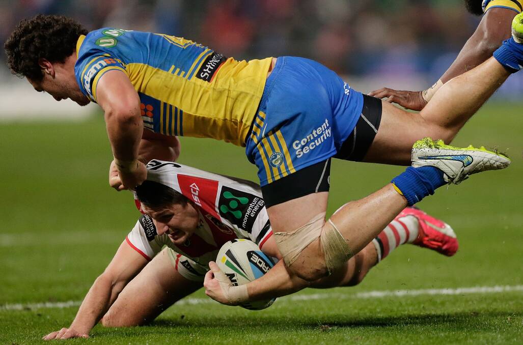 Gareth Widdop of the Dragons is tackled by Brad Takairangi of the Eels during the Round 16 NRL match between the Parramatta Eels and the St George Illawarra Dragons at Pirtek Stadium. Picture: GETTY IMAGES