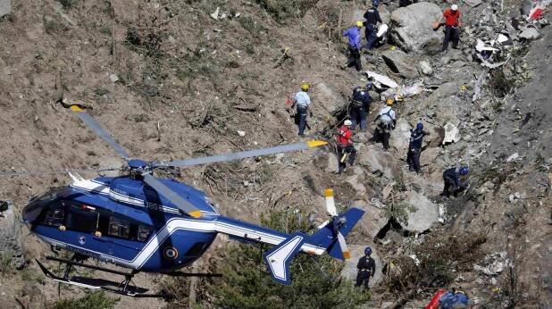 French investigators work through the debris of the crash in the French Alps. Picture: REUTERS
