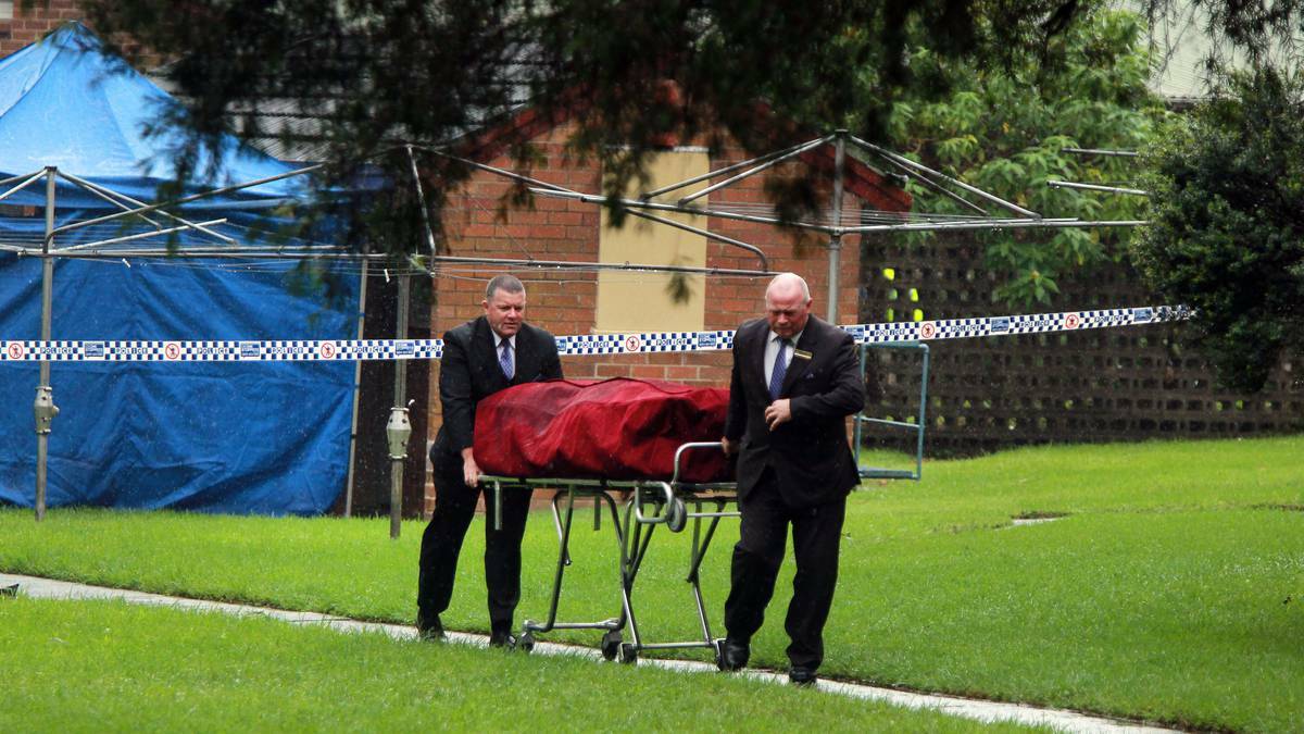 A body is removed from a Mangerton housing complex on Thursday. Picture: SYLVIA LIBER
