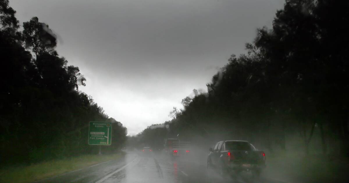 Heavy rain is making driving difficult heading northbound along the M1 Motorway at Berkeley. Picture: KIRK GILMOUR