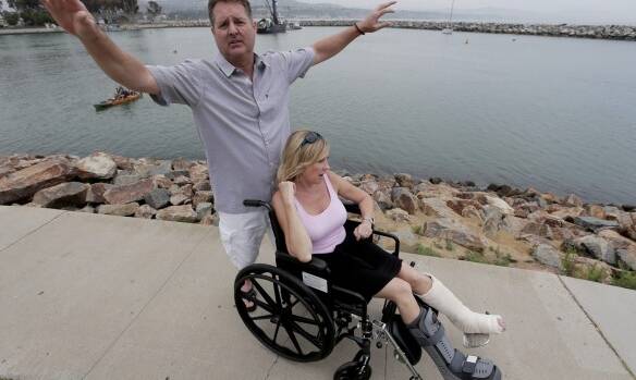 Dirk Frickman describes how a dolphin leaped into his boat in Southern California, breaking both of his wife Chrissie's ankles. Picture: AP