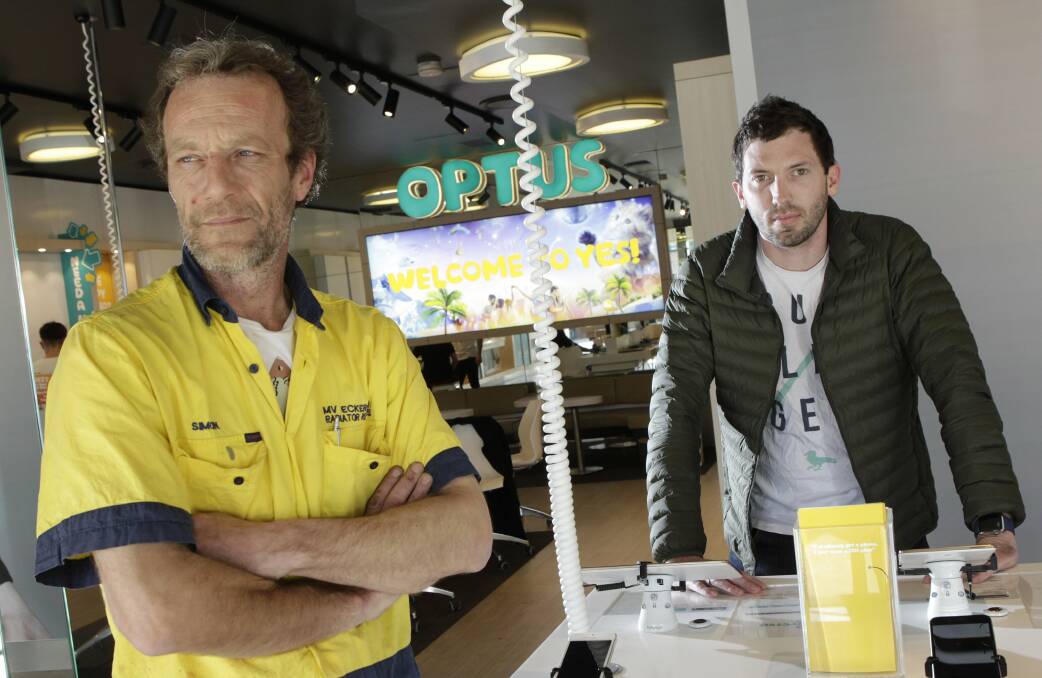 'Radiator Hero' Simon Eckersley (left) foiled an alleged robbery at the North Wollongong Optus shop earlier this week. He is pictured with grateful Optus shop manager owned Tony Story. Picture: ANDY ZAKELI