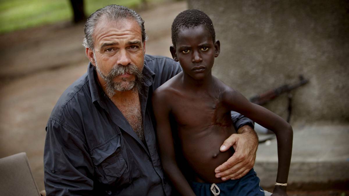 The Machine Gun Preacher, Sam Childers, with one of the children he cared for in Southern Sudan. Picture supplied