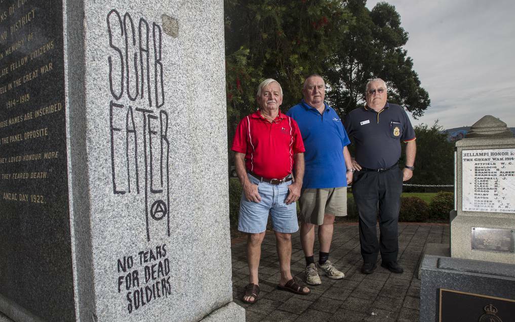 Corrimal sub-branch vice-president Neil Mclean, treasurer Harry Bassett and welfare officer Ray Morgan at Corrimal’s war memorial where vandals have knocked a large chunk out of a granite pillar and scrawled offensive graffiti on another. Picture: CHRISTOPHER CHAN
