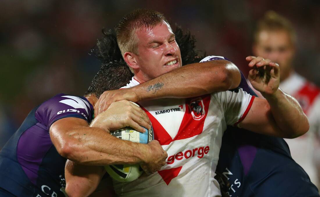 Mike Cooper of the Dragons is tackled during the round one NRL match between the St George Illawarra Dragons and the Melbourne Storm at WIN Jubilee Stadium. Picture: MARK KOLBE 