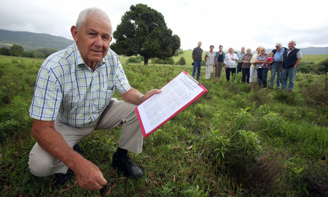 Jamberoo resident Reg Curnow holding a petition signed by residents opposed to the development. Picture: ROBERT PEET