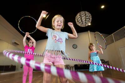 (L-R) Cassia White, 6, Freyja Shingler, 7 and Lara McMillan, 3 get creative with hula hoops. Picture: CHRISTOPHER CHAN