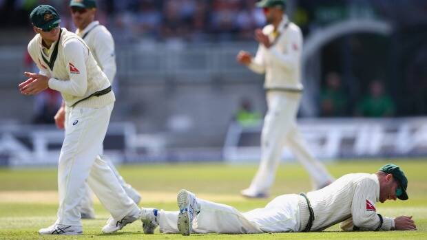 Tough match: Michael Clarke lies grounded after spilling a catch from Ian Bell at second slip. Picture: GETTY IMAGES

