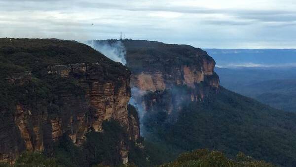 Fire crews are concentrating fire fighting efforts at the top of a cliff as the Wentworth Falls fire is driven by strong winds. Picture: NSW RURAL FIRE SERVICE