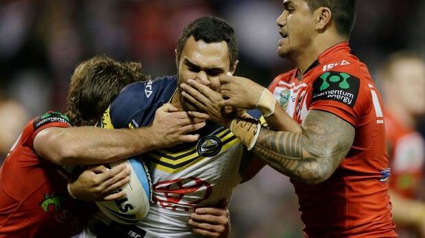 Peter Mata'utia wrestles with Justin O'Neil in the Dragons 18-12 loss to the Cowboys. Picture: Getty Images