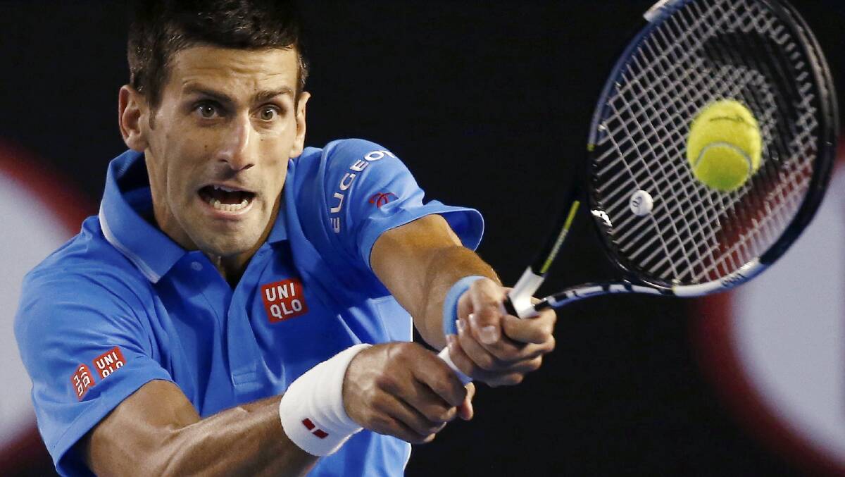 Novak Djokovic hits a backhand during his straight sets quarter-final win over Canada's Milos Raonic in Melbourne on Wednesday night. Picture: GETTY IMAGES