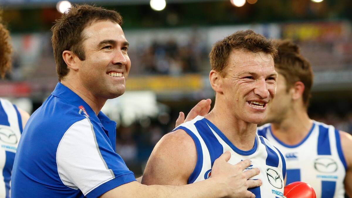 North Melbourne coach Brad Scott congratulates Brent Harvey after the First Elimination Final against the Richmond Tigers. Picture: GETTY IMAGES