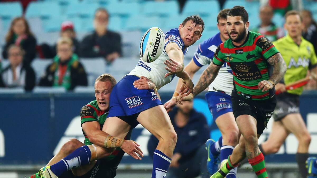 Brett Morris of the Bulldogs offloads against the South Sydney Rabbitohs at ANZ Stadium on Friday night. Picture: GETTY IMAGES
