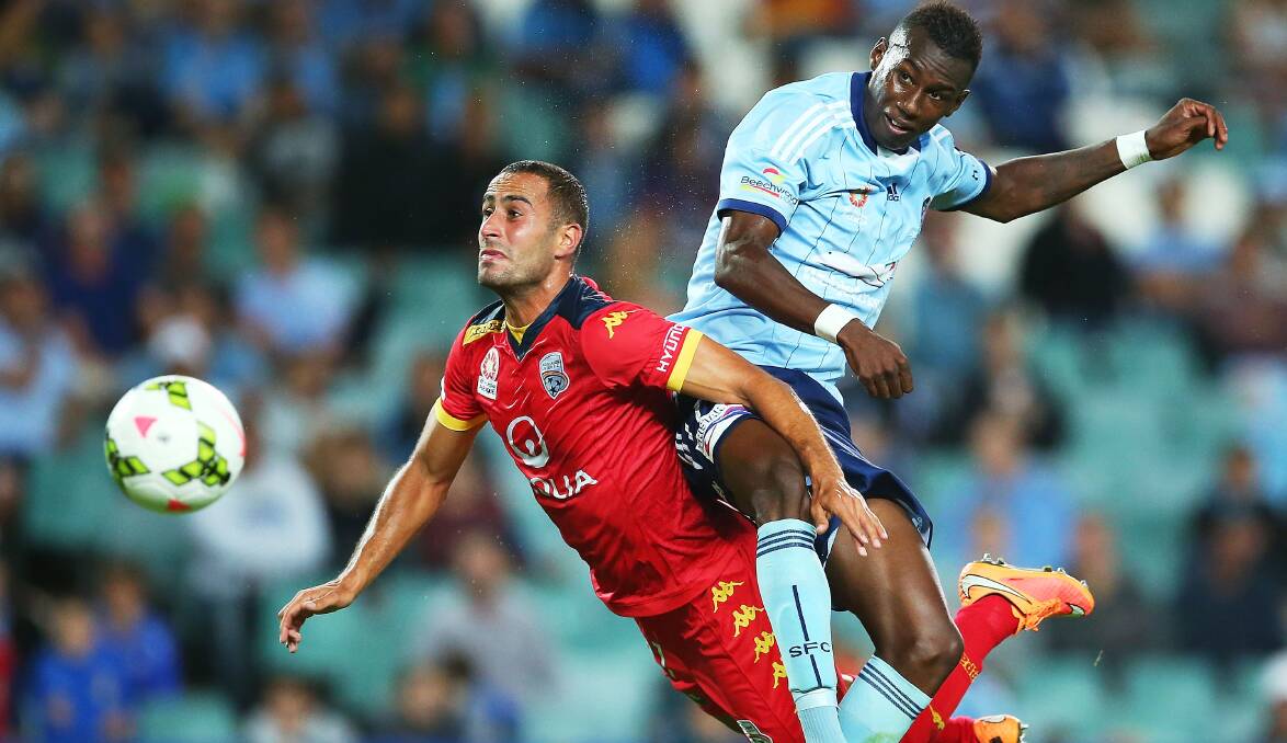Tarek Elrich of Adelaide competes with Bernie Ibini of Sydney during the A-League match at Allianz Stadium on Friday night. Picture: GETTY IMAGES