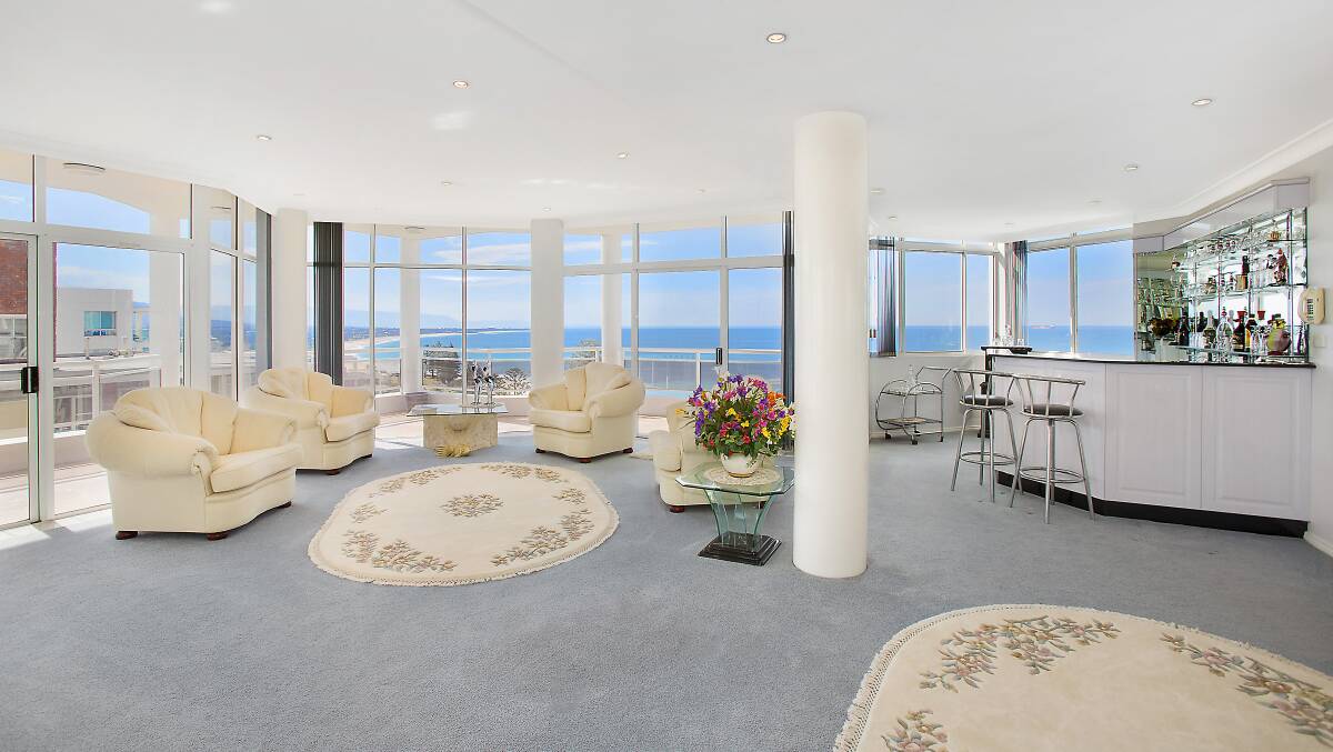 The two-level luxury penthouse has wrap-around balconies, amazing sea views, four bedrooms and four-car garaging.