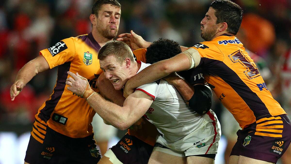 Dragons captain Ben Creagh is triple-teamed by Broncos tacklers at Kogarah on Friday night. Picture: GETTY IMAGES 