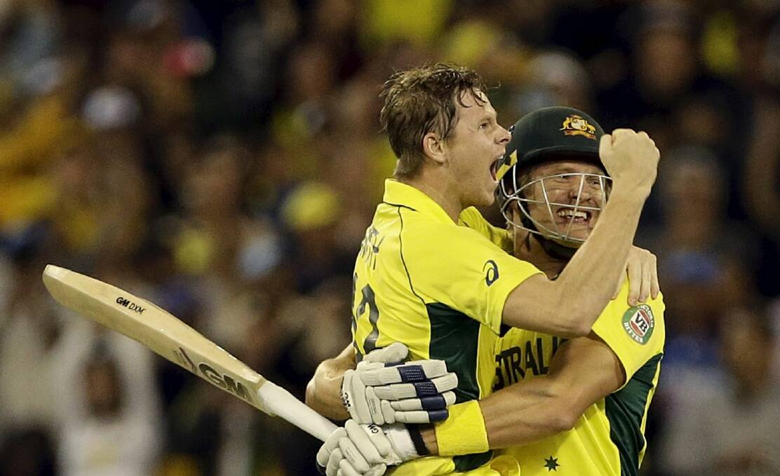 Australian cricketers Steve Smith and Shane Watson celebrate after beating New Zealand in the World Cup final at the MCG. Picture: REUTERS