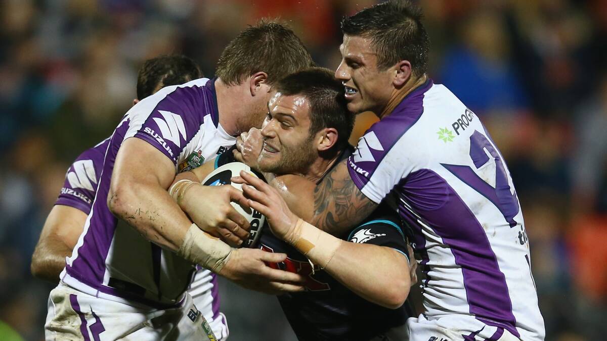 Melbourne Storm tacklers wrap up Penrith's Tim Grant at Sportingbet Stadium on Monday night. Picture: GETTY IMAGES