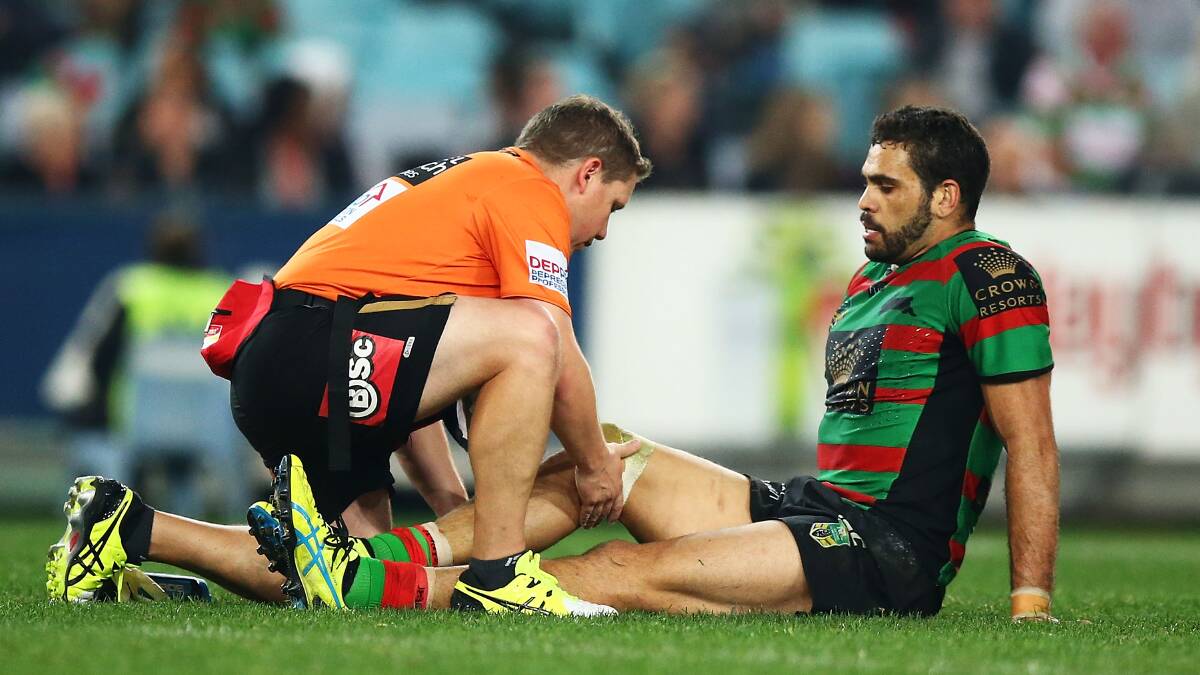 Greg Inglis receives attention for his knee injury on Friday night. Picture: GETTY IMAGES
