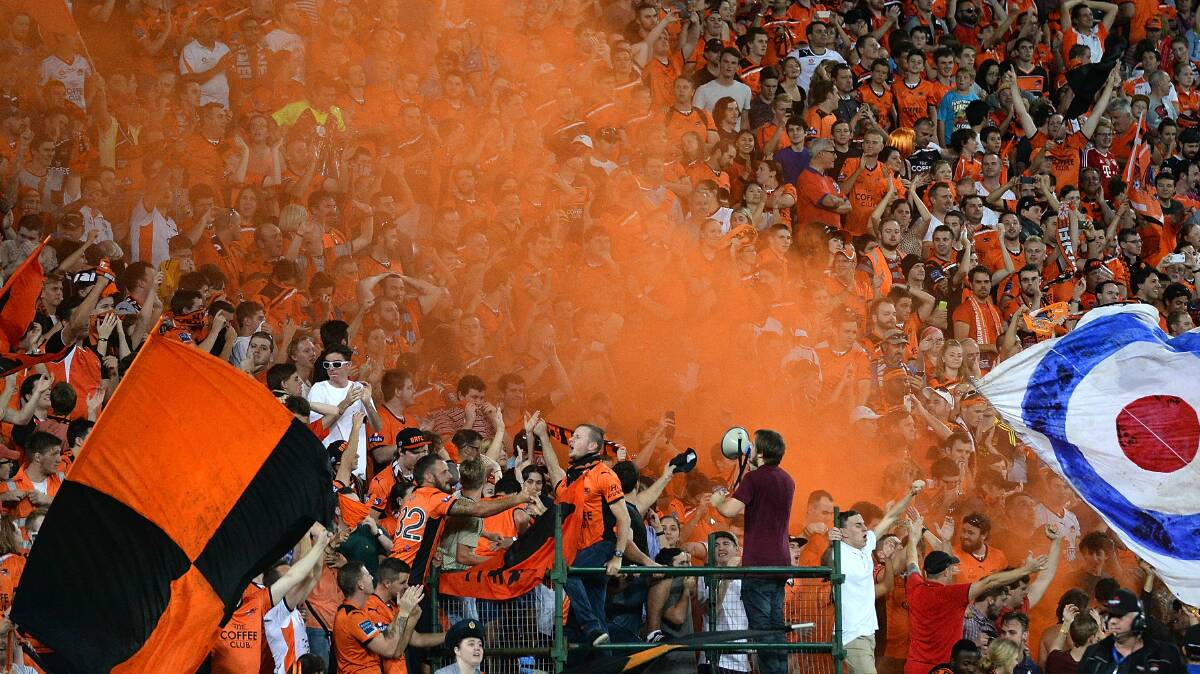 Roar fans celebrate after their team qualified for the A-League grand final. Picture: GETTY IMAGES