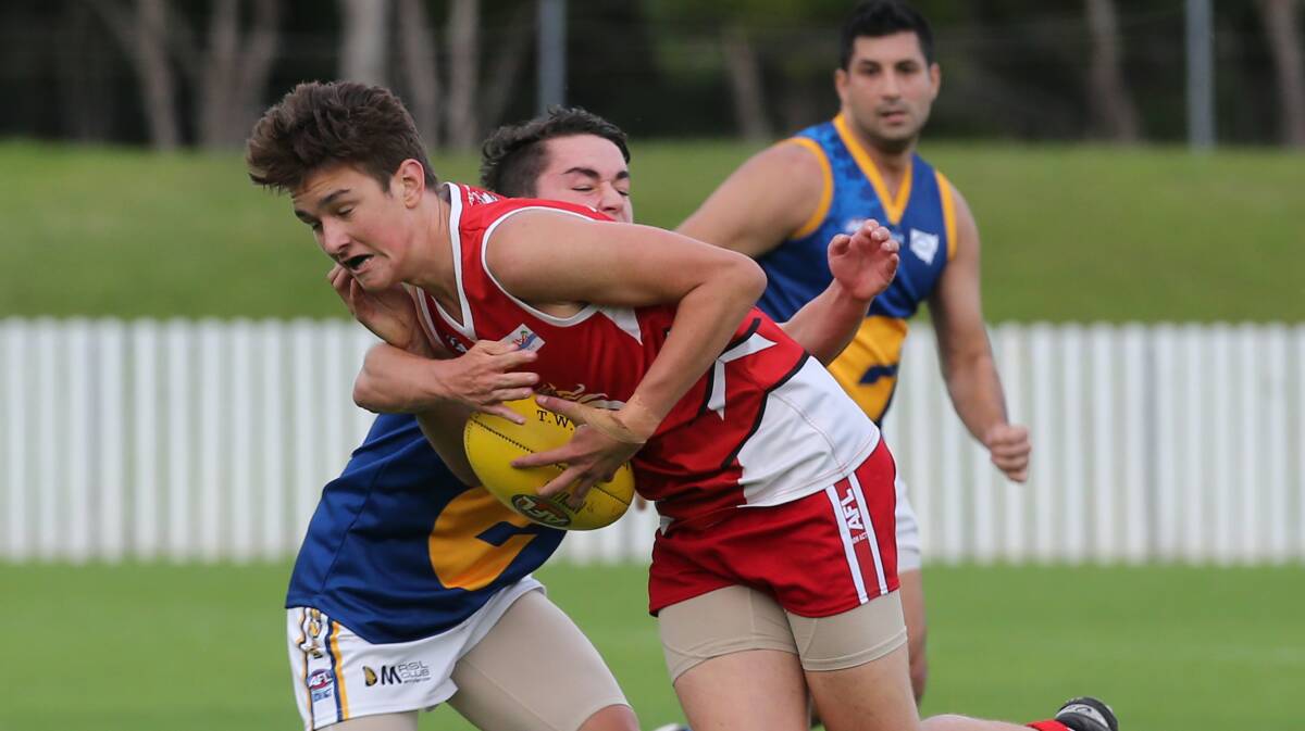 Illawarra Lions player Jack Thompson attempts to break a tackle during a game against Holroyd in the Sydney AFL competition last season. Picture: ROBERT PEET

