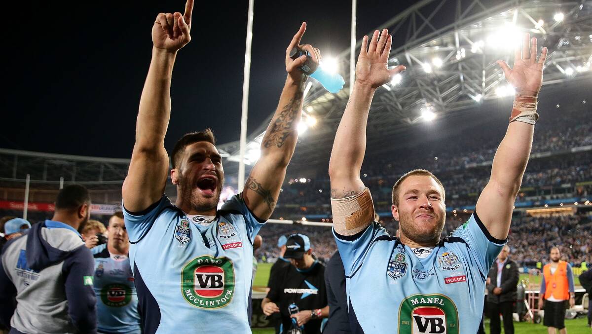 NSW duo James Tamou (left) and Trent Merrin celebrate winning the State of Origin series in game two at ANZ Stadium last month. Picture: GETTY IMAGES