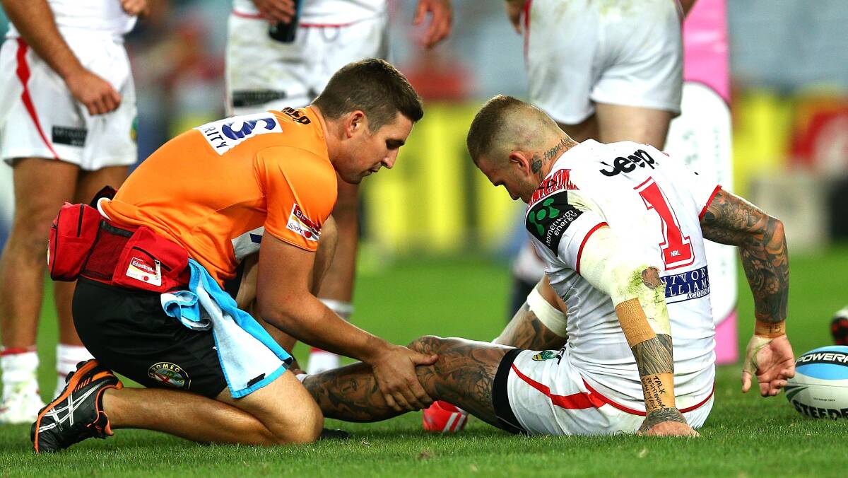 Dragons fullback Josh Dugan receives treatment for a knee injury during Saturday night's Charity Shield clash. Picture: GETTY IMAGES
