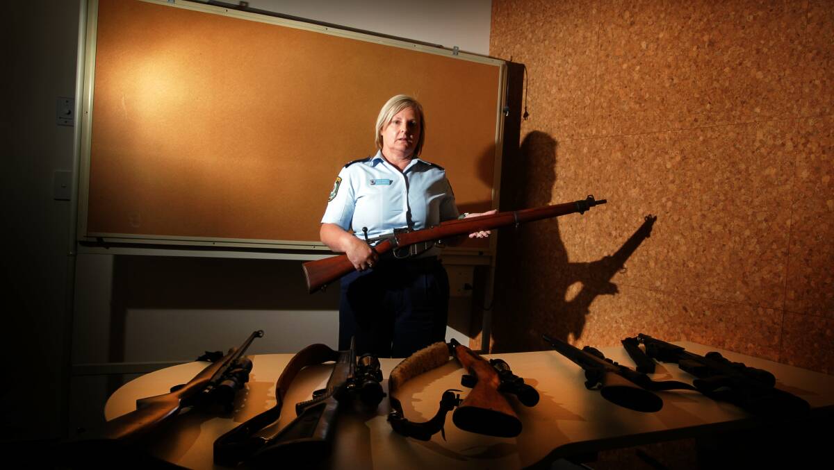 Senior Constable Diane Martin with some of the firearms seized by  Lake Illawarra police attending domestic violence situations. Picture: SYLVIA LIBER